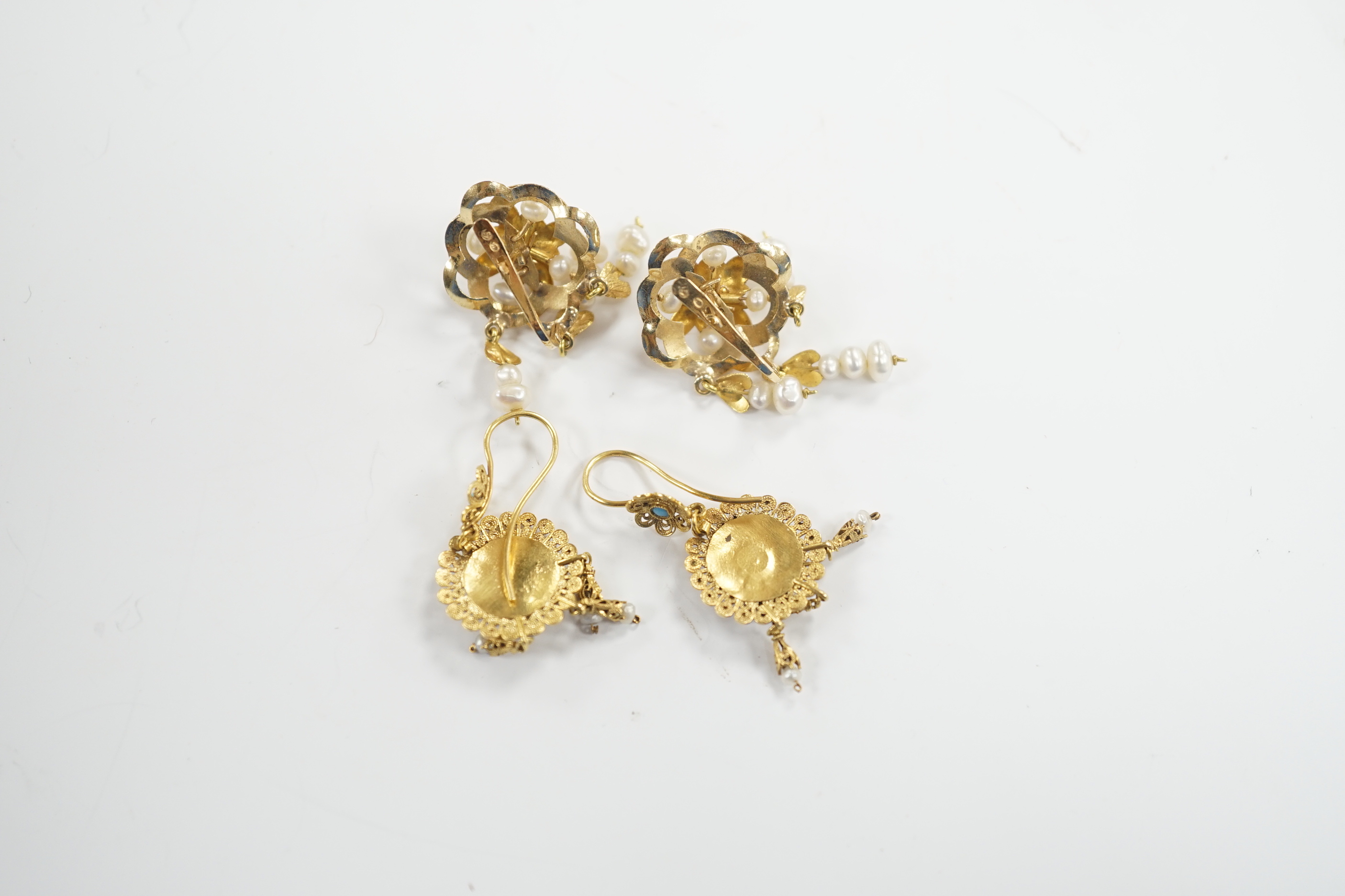 A pair of continental yellow metal and cultured pearl cluster set drop earrings, 36mm and a pair of yellow metal filigree, seed pearl and turquoise set drop earrings, gross weight 10.9 grams.